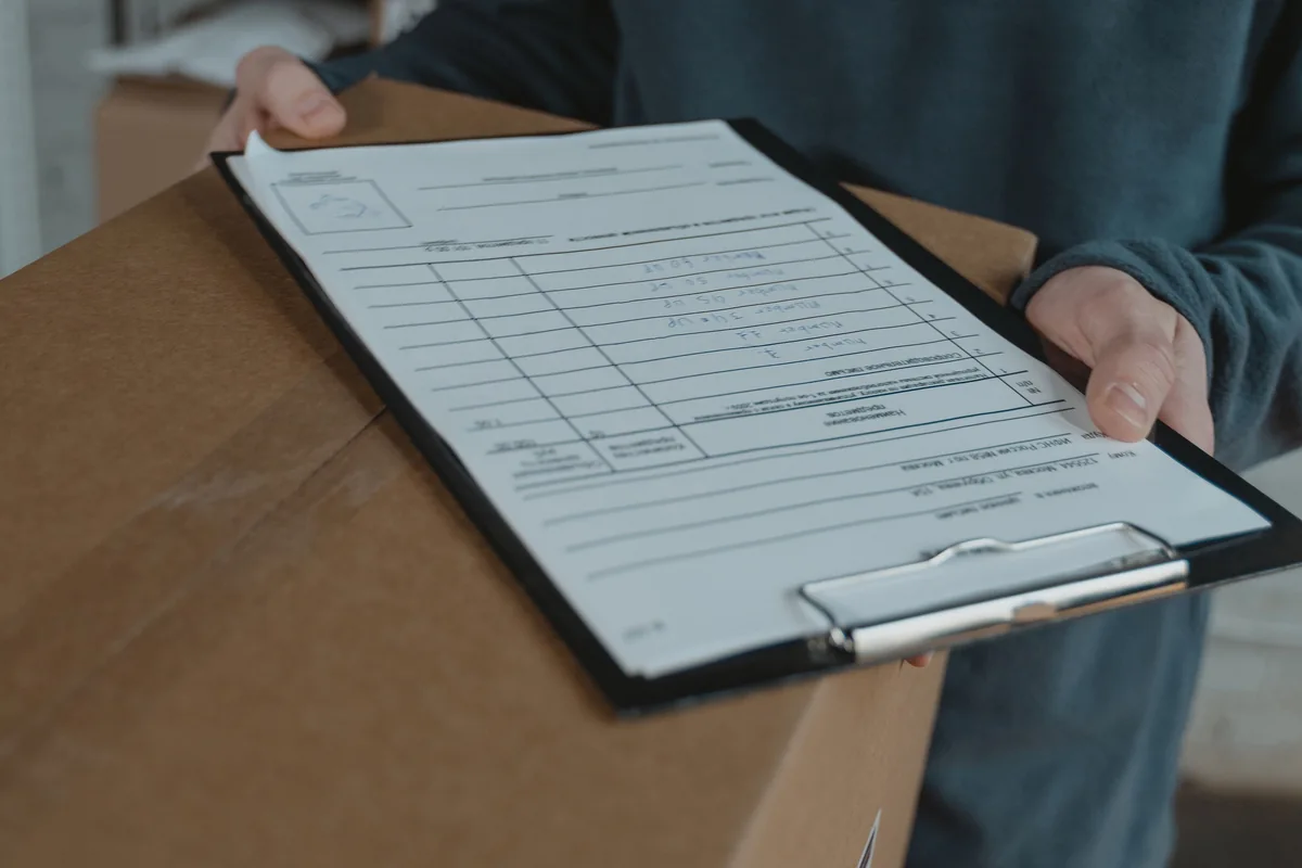 A parcel and shipping checklist being reviewed before dispatch.