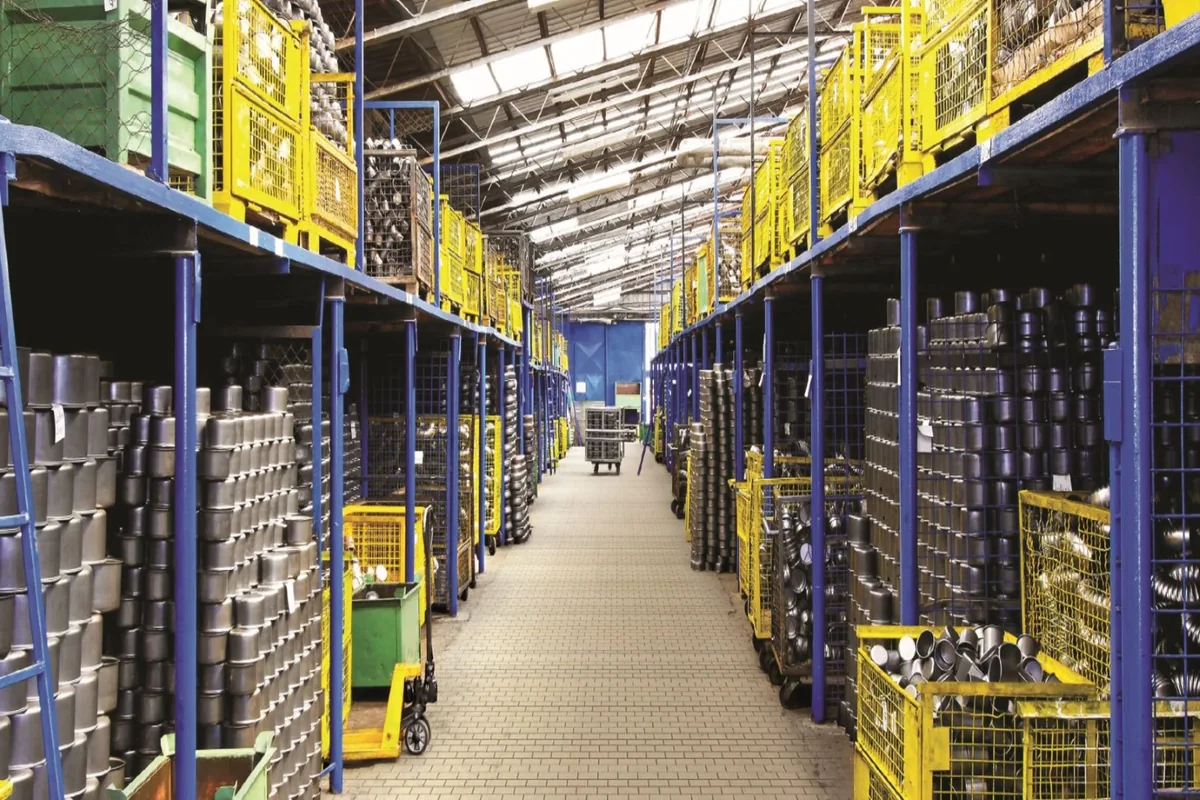 Organized warehouse racks lining a spacious industrial aisle.